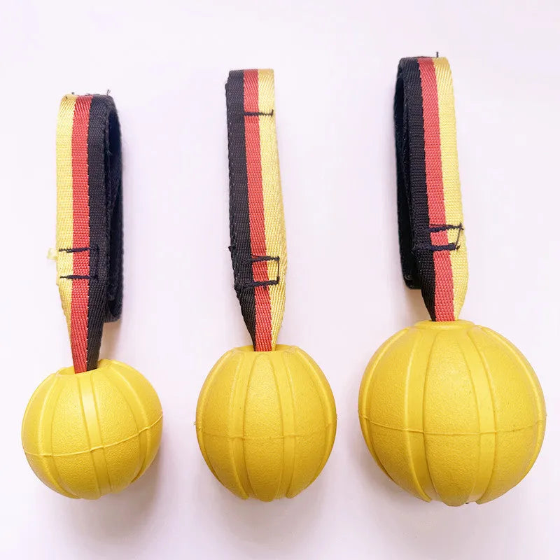 Yellow and camouflage coloured EVA floating dog training balls in different sizes on a blue background.