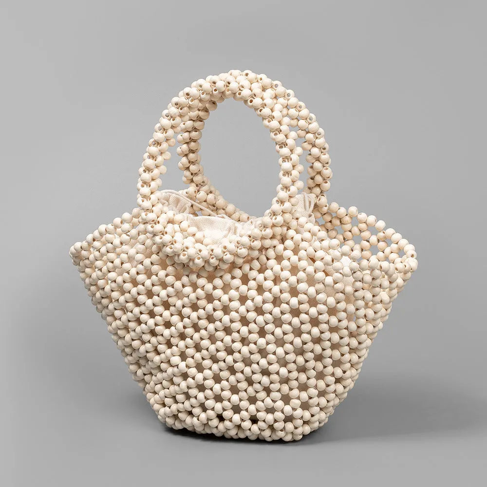 Hand-woven maple beach bag with wooden bead decoration showing hollow dumpling design