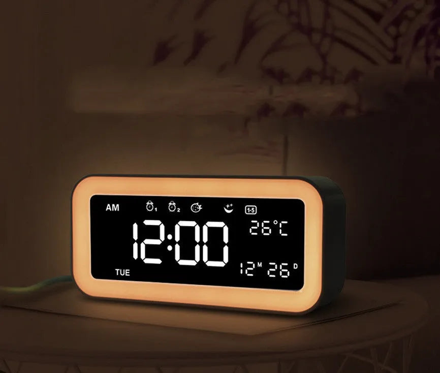 Rectangular blue LED atmosphere alarm clock with digital display on a wooden surface.