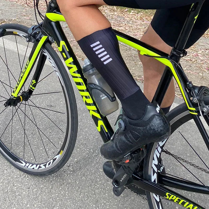 Pair of breathable athletic sports socks for cycling and running in a chemical fibre blend fabric.