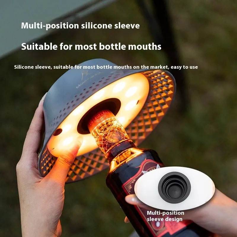 Beige wine bottle shaped camping lantern showing three light modes and USB-C port.