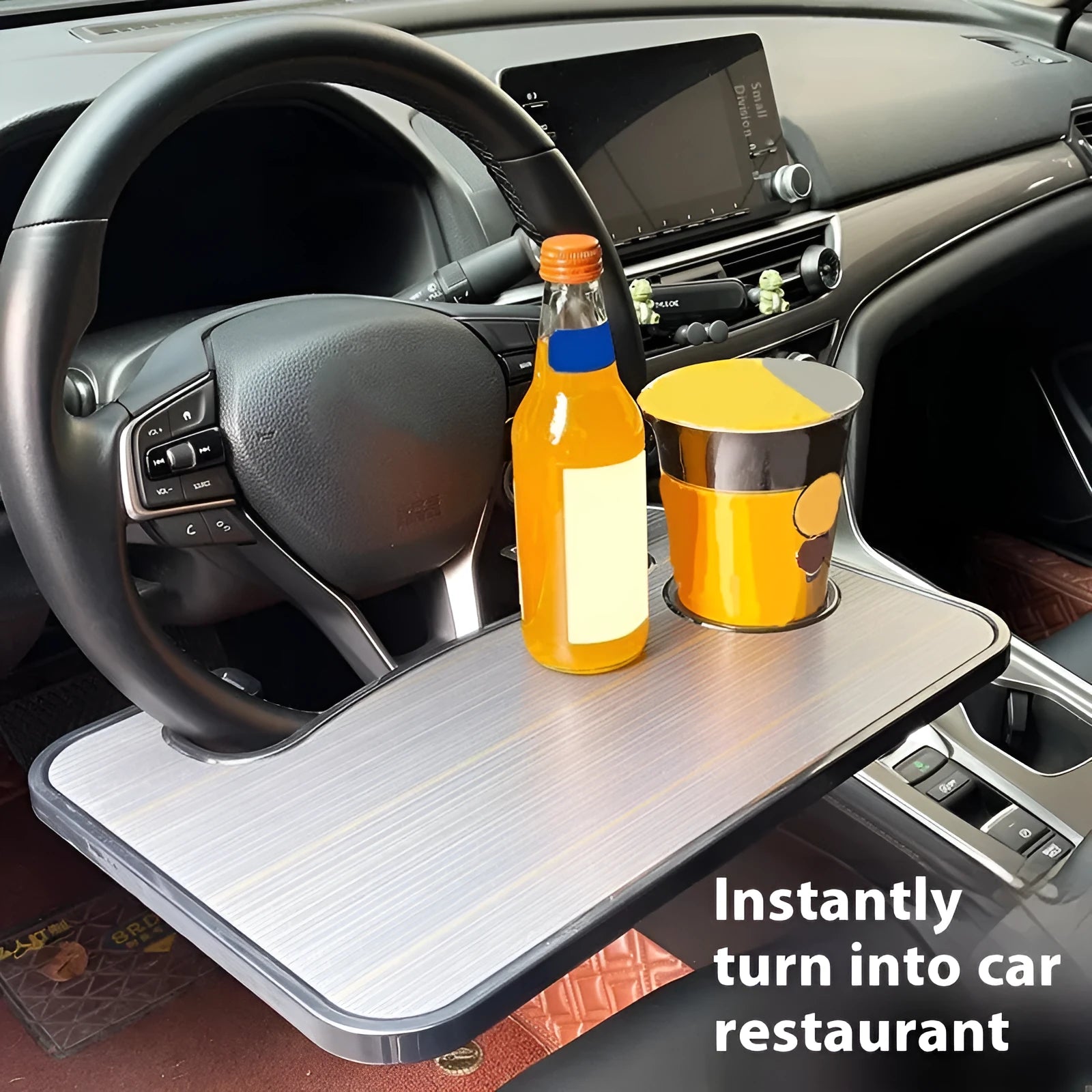 Black ABS car tray with foldable drink cup holder on a car passenger seat