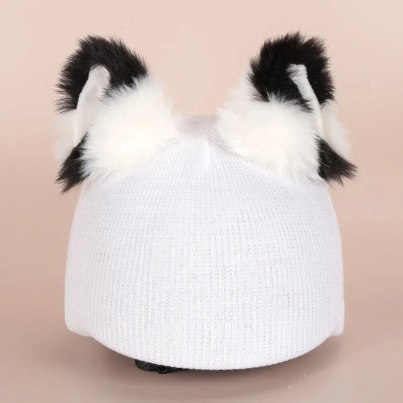 Soft plush cartoon character cover on a motorcycle helmet, showing size M and decorative ear sections.