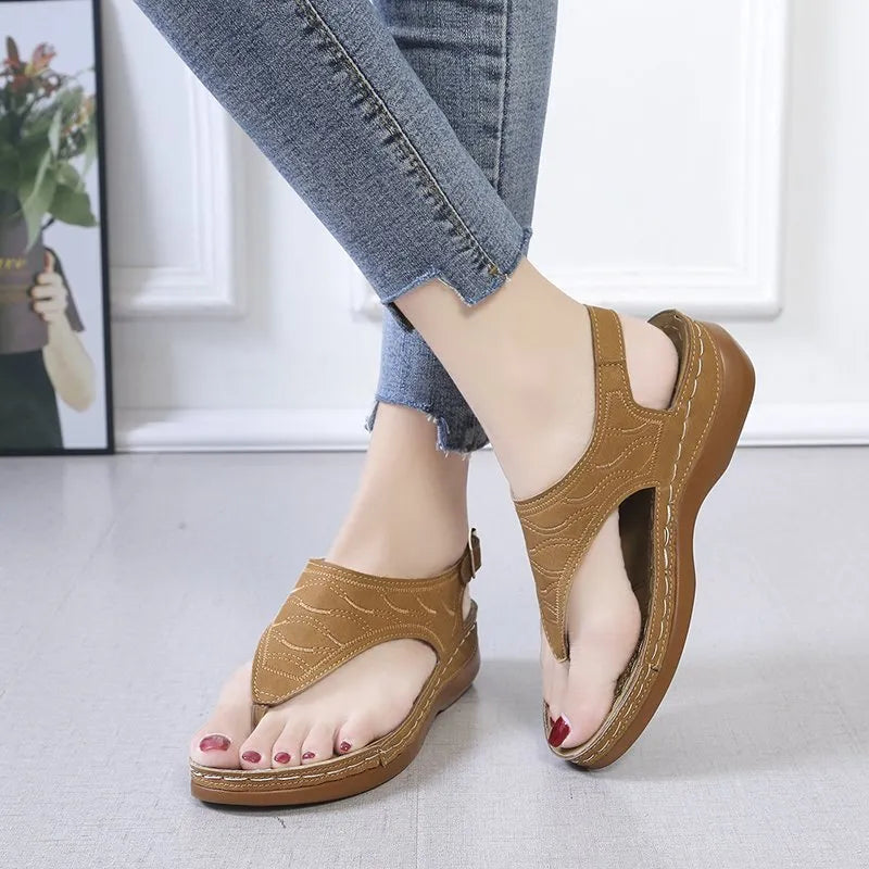 Women's red wedge heel sandals with an adjustable back strap buckle.