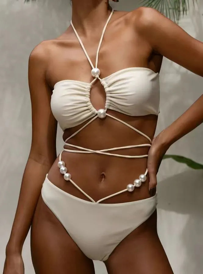 Women's black split lace-up bikini swimsuit with brief shorts and sleeveless bra top.