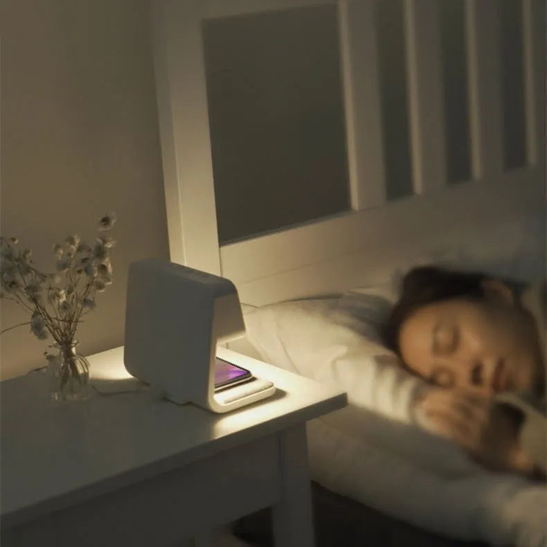 White 3-in-1 bedside table lamp with wireless charging pad, LCD screen, and touch dimmer.