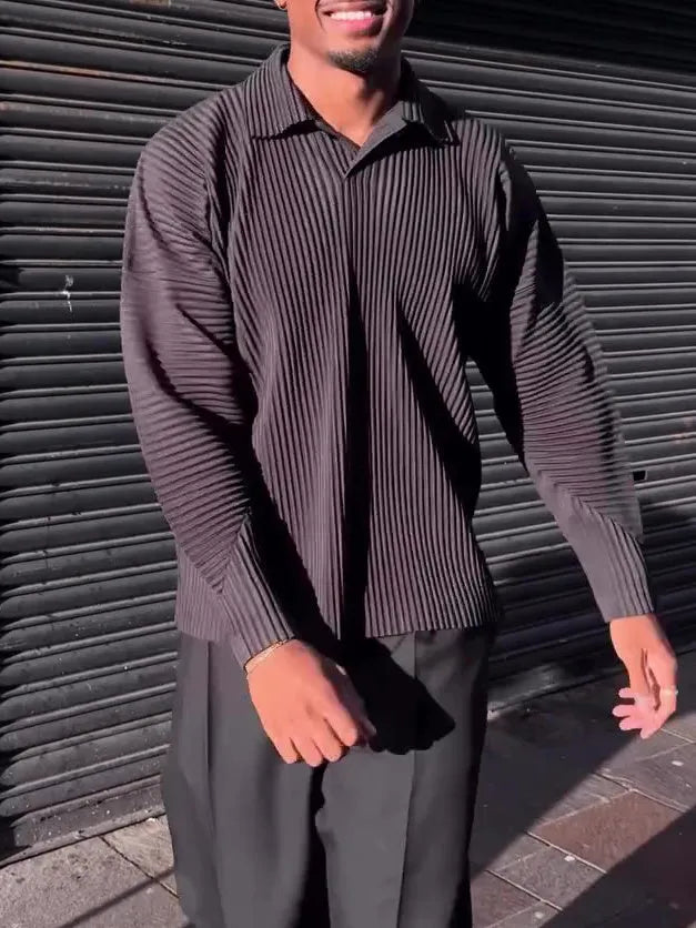 Black men's pleated long-sleeved polyester top showing vertical texture detail