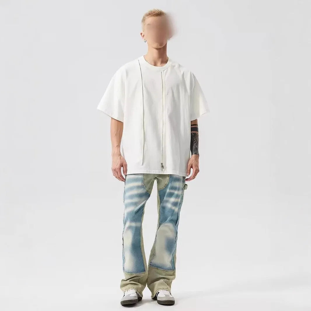 Retro yellow and blue patchwork jeans with splash-ink damaged design on denim fabric