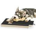 Black wooden dog nail scratch board with treat drawer and non-slip base pads.