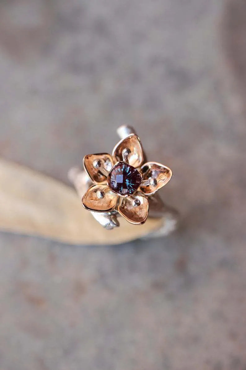 Silver two-tone floral geometric alloy women's ring on a plain background.