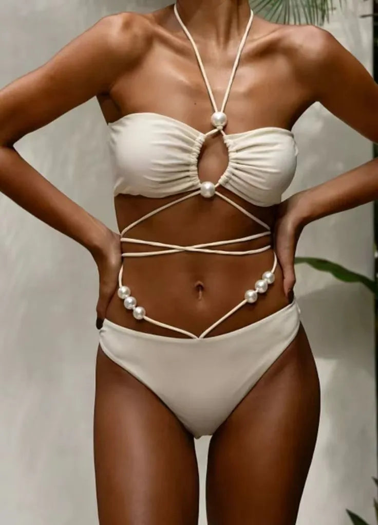 Women's black split lace-up bikini swimsuit with brief shorts and sleeveless bra top.