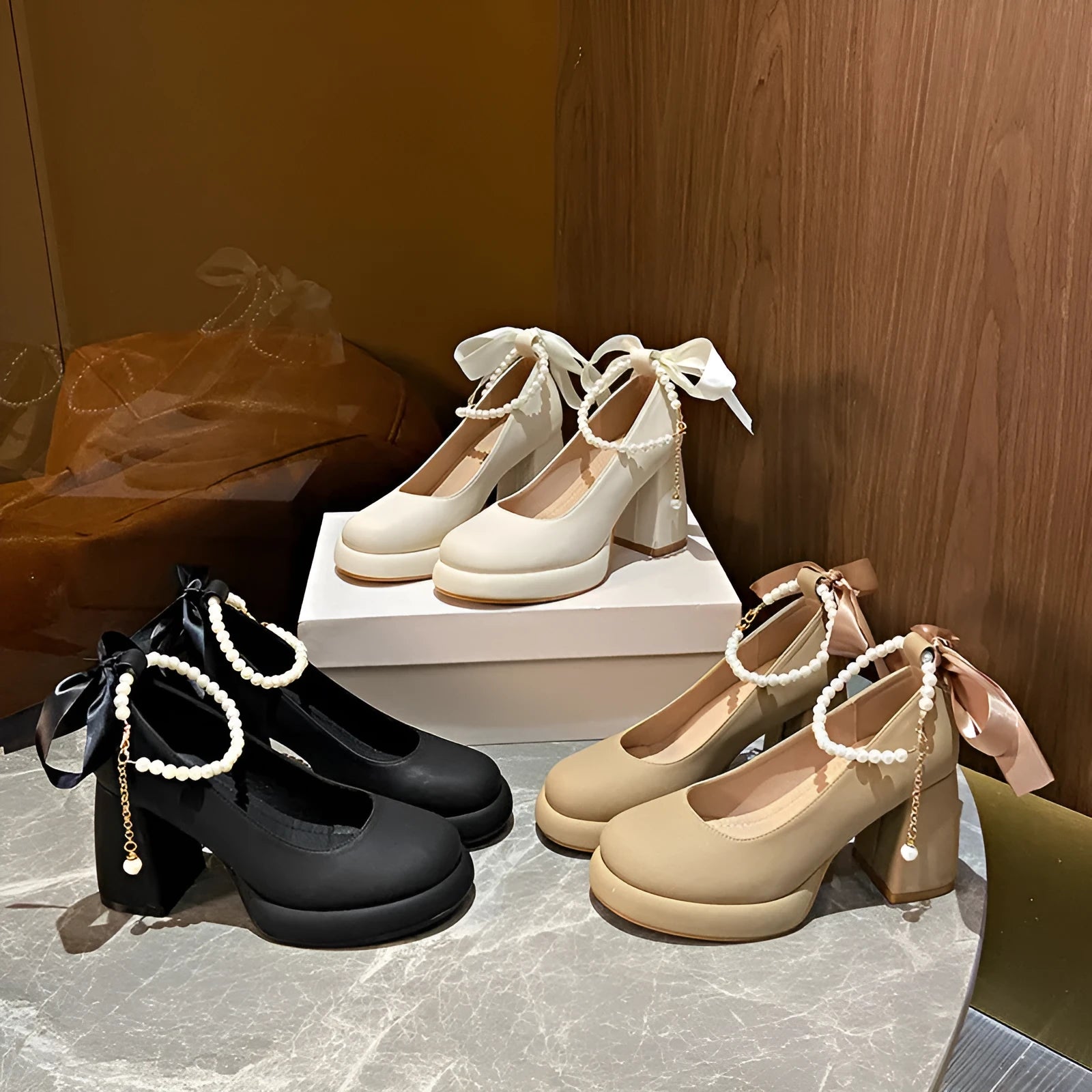 Beige women's Mary Jane shoes with chunky heel, ankle strap, pearl detail, and round toe.