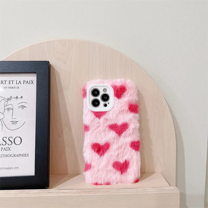 Pink silicone iPhone case featuring a Love Plush cartoon design on the back.