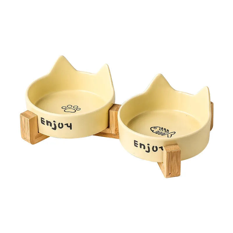 Porcelain cat bowl with wooden frame featuring cat paw pattern in pink colour
