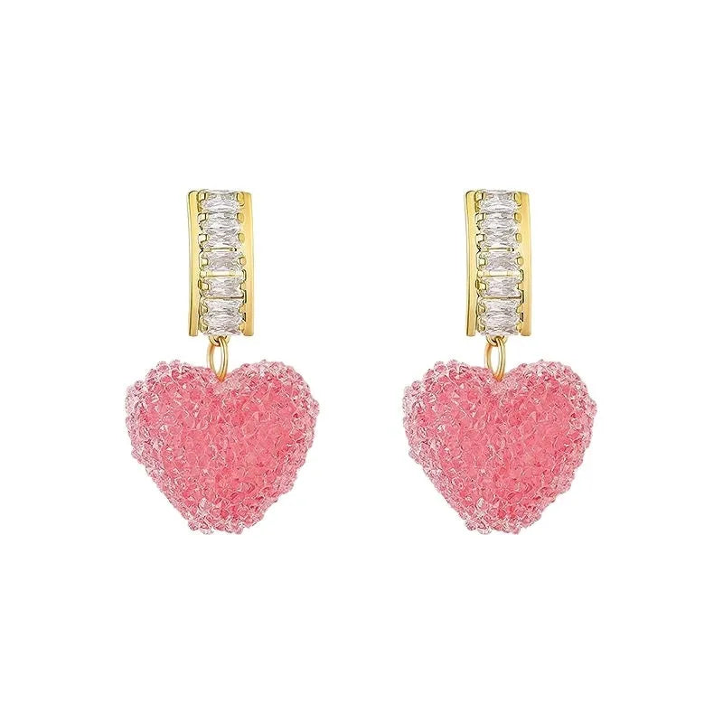 Pair of pink heart-shaped candy stud earrings made from alloy on a white background.