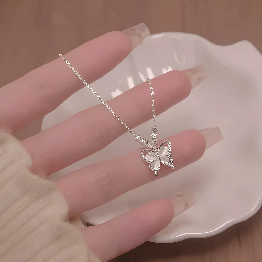 Silver square line opal butterfly pendant necklace on a cross chain for women.
