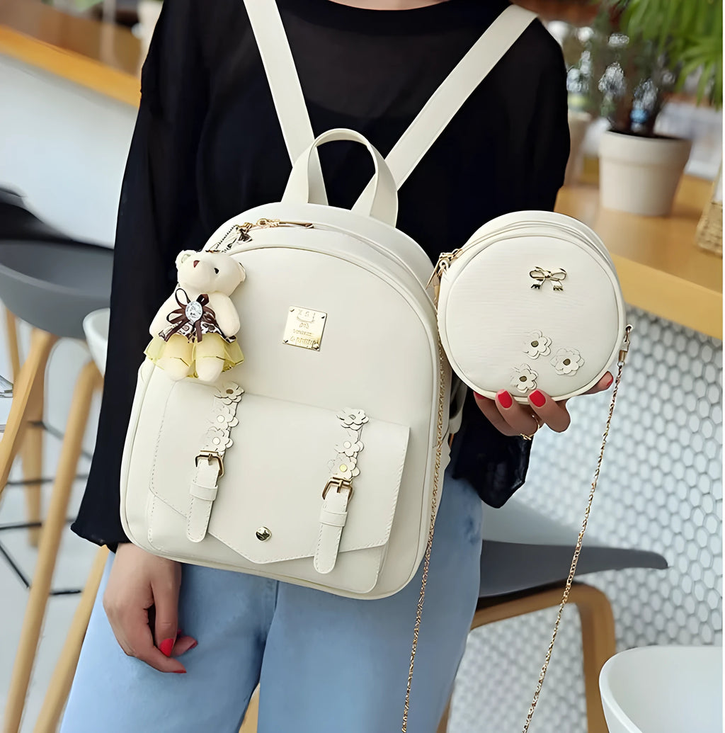 Women's three-piece PU leather bag set showing backpack, shoulder bag and card holder in matching colour.