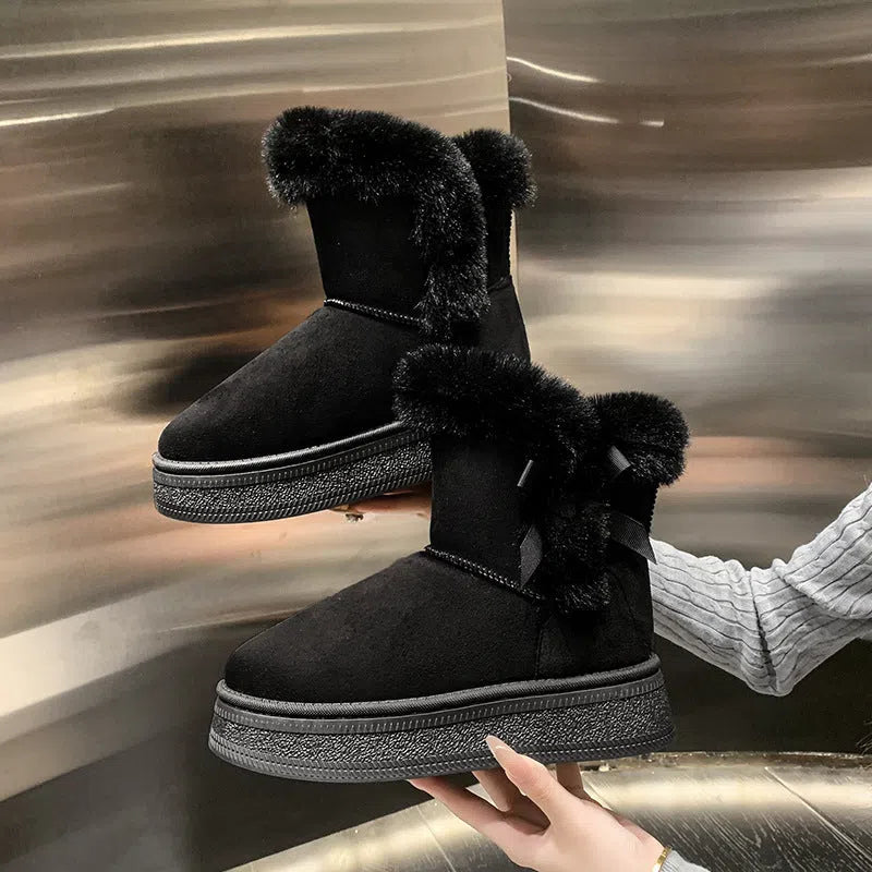 Women's mid-calf suede snow boots with faux fur lining, 1–3 cm thick rubber sole, and bow tie detail, shown in brown, black, or white.