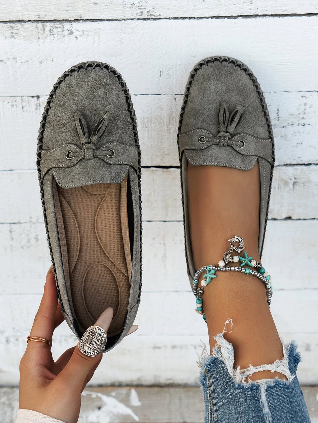 Women's apricot suede flat shoes with a bow detail on the front, showing round toe and low-top design.