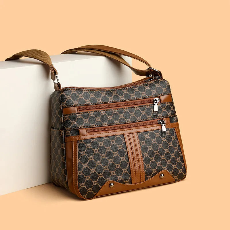 Brown women's crossbody bag with stitching pattern and adjustable shoulder strap.