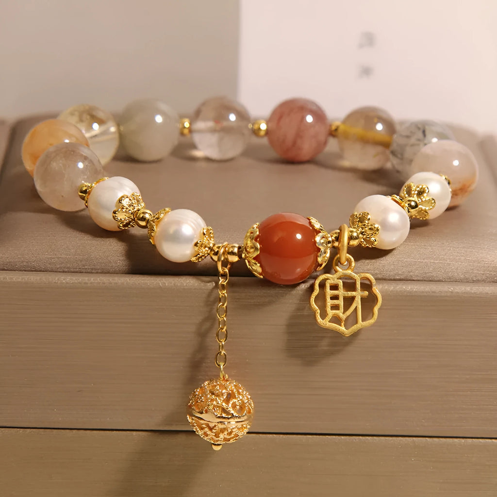 Women's crystal bracelet with colourful hair crystal beads, four pearls, and a Chinese Cai charm.