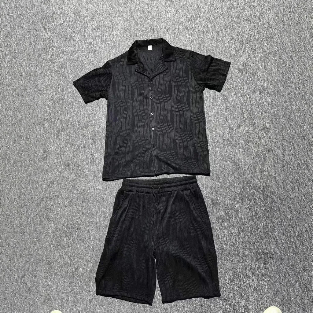 Men's black wave pattern short sleeve top and matching shorts casual set on a hanger.