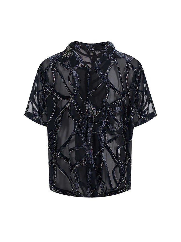 Man's black and grey snake pattern short-sleeved shirt with loose fit and lapel collar.