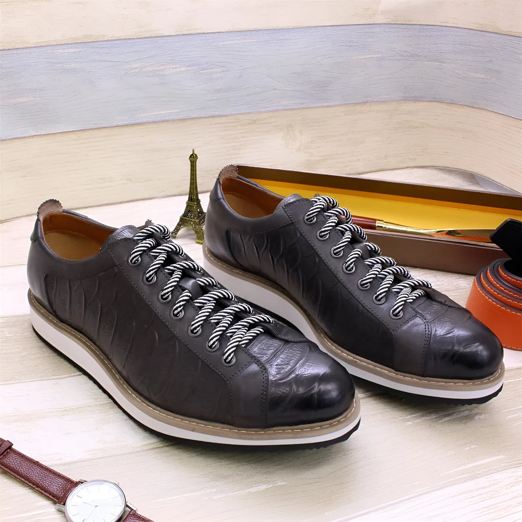 Men's black embossed pattern low-top lace-up trainers on a white background