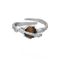 Saturn design adjustable silver ring with white gold electroplated finish and tigereye open pattern