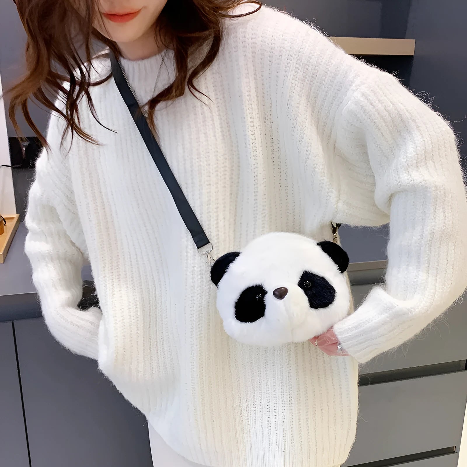 Soft plush panda head design crossbody bag showing cylindrical shape and outer pocket.