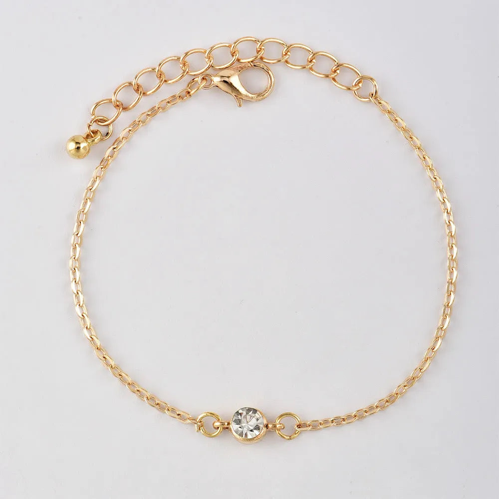 Gold alloy geometric bangle combination set with electroplated finish and about 16cm diameter