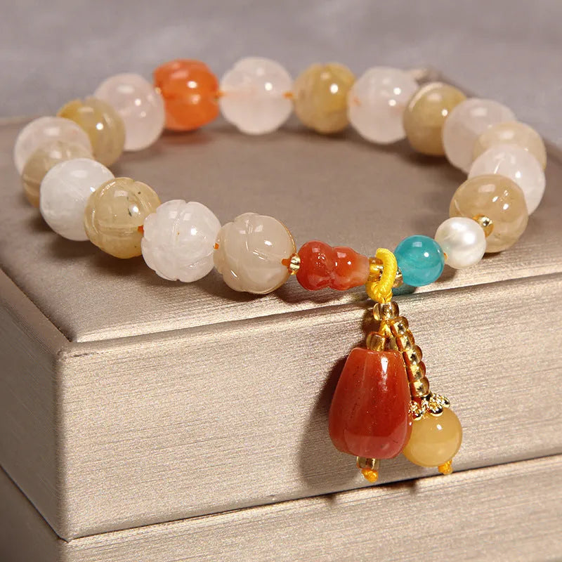Yellow agate stone bracelet for women with gold silk threading on a wrist