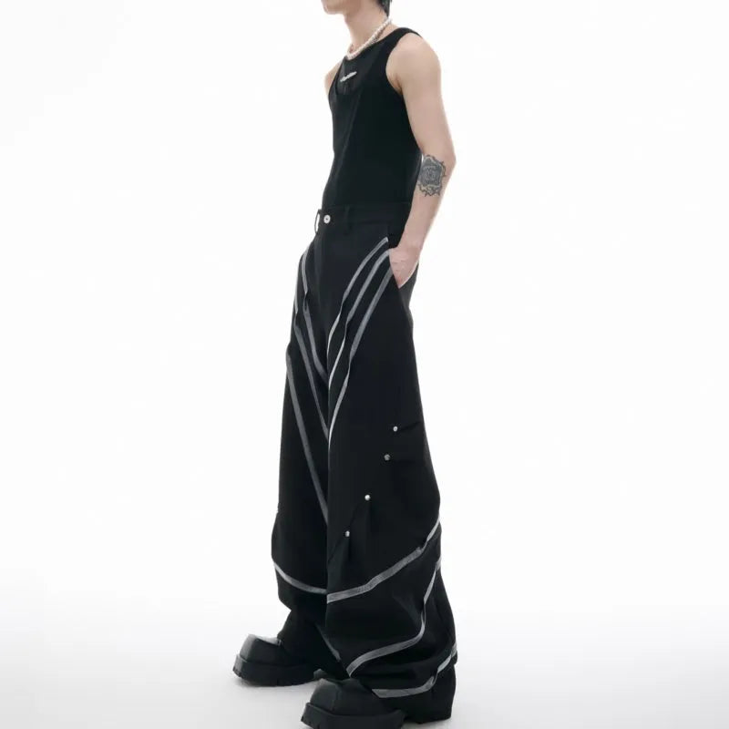 Men's black polyester trousers with metal striped rivet details and pleated front.