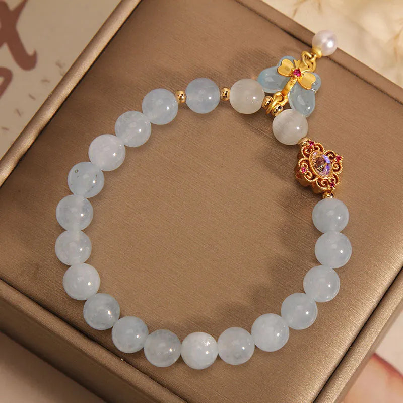 Women's crystal bracelet with a blue aquamarine butterfly pendant and sparkling rhinestone details on an adjustable chain.