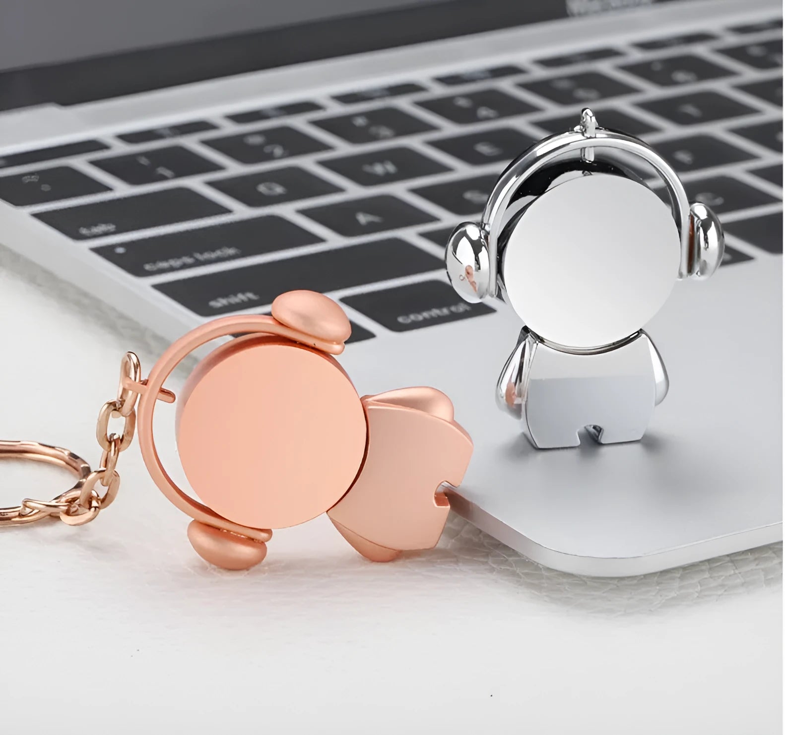 Silver and rose gold metal USB flash drives with a cartoon musician graphic design.