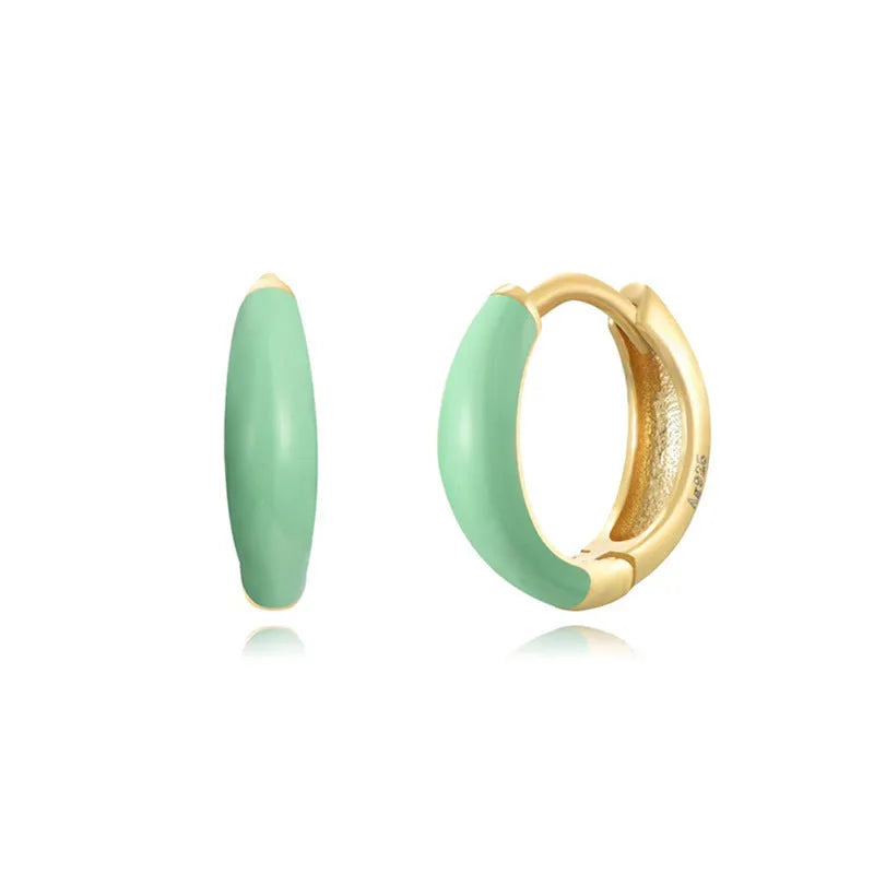 A pair of curved oval epoxy earrings on a U-shaped silver-plated copper base.