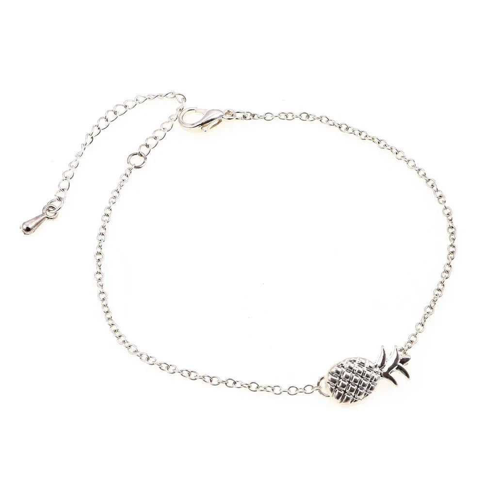 Gold or silver tone alloy bracelet with a central pineapple charm on a model's wrist.