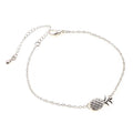 Gold or silver tone alloy bracelet with a central pineapple charm on a model's wrist.
