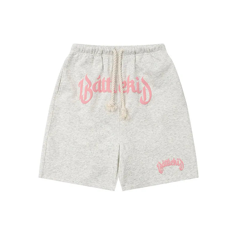 Women's loose-fit cotton blend cropped sweatpants in black, shown in a casual street style.