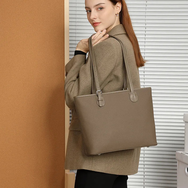 Women's genuine leather tote bag 30cm wide in black colour showing internal zipper compartments and retro styling