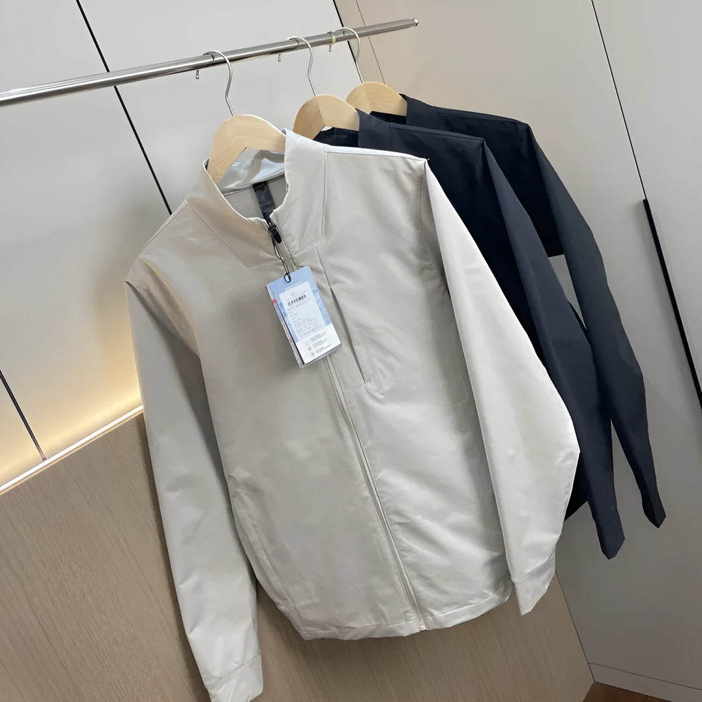 Men's beige stand collar casual sports jacket with long sleeves on a hanger.