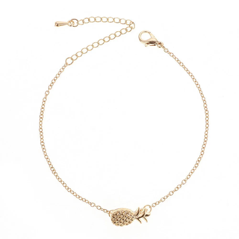 Gold or silver tone alloy bracelet with a central pineapple charm on a model's wrist.