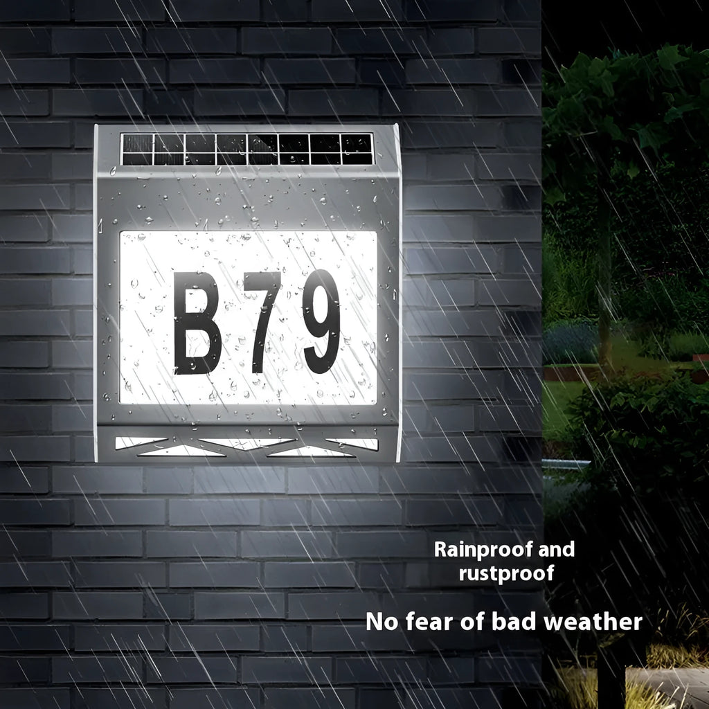 Black solar powered doorplate light with digital LED display showing house numbers