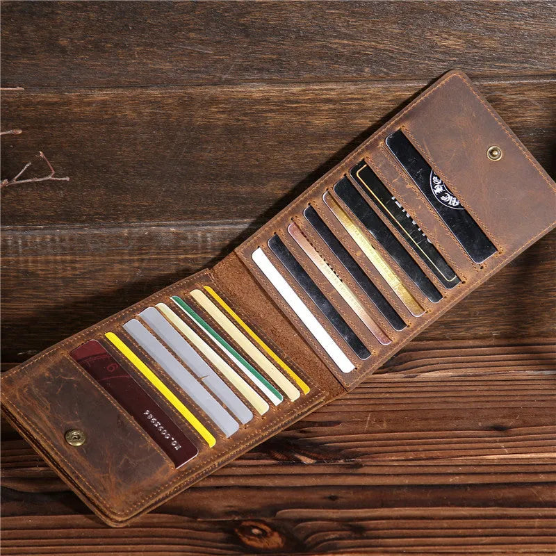 Slim black leather men's wallet open to show 18 card slots and a central mobile phone pocket.