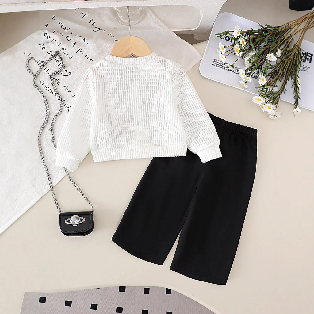 White floral long sleeve top and black trousers baby outfit set in cotton, sizes 6-9M to 2-3Y