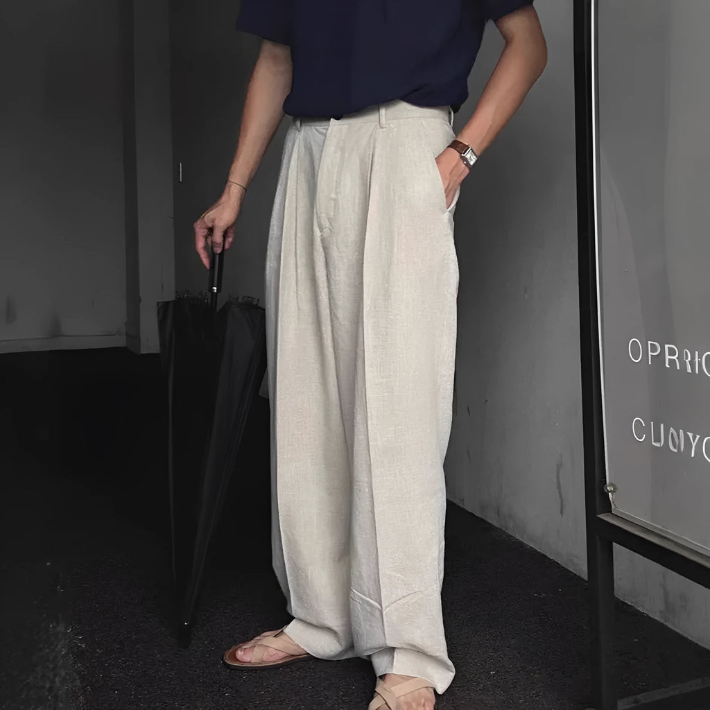 Men's apricot wide-leg cotton linen trousers with a loose fit and pencil leg opening.