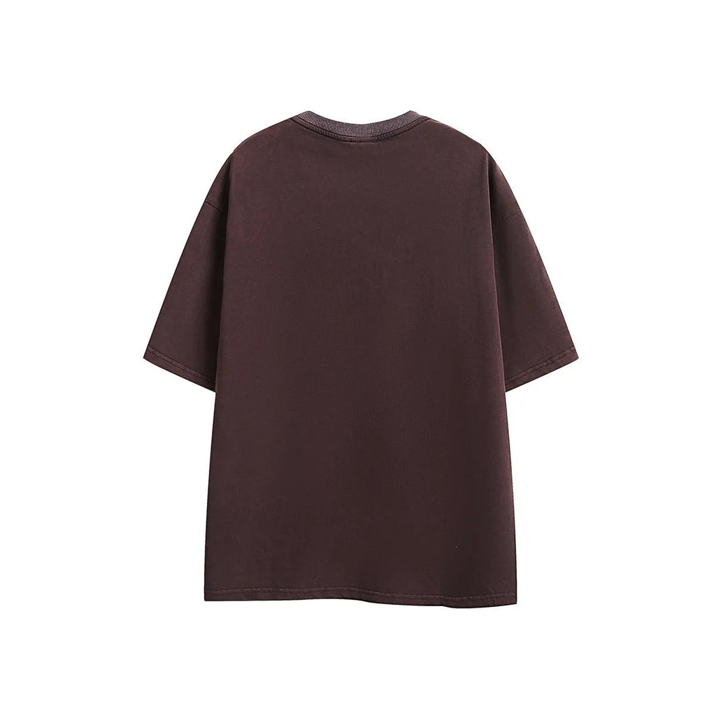 Man's purple loose-fit cotton t-shirt with a retro embroidered design on the chest.