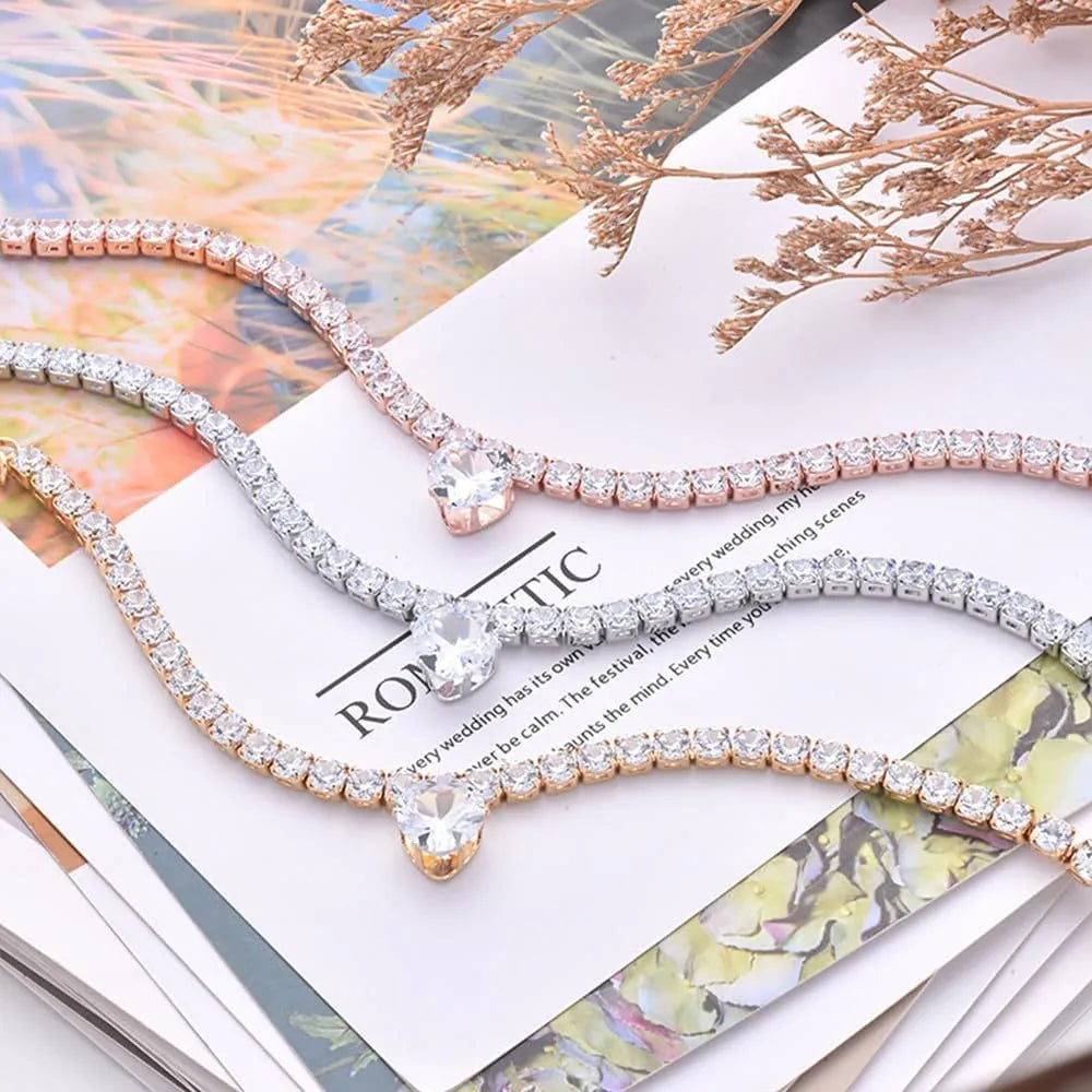 Gold rhinestone heart-shaped collar for dogs and cats on a metal chain.