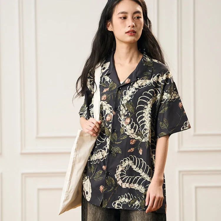 Short sleeve Cuban collar shirt featuring a printed snake bone and flower pattern in a loose fit.