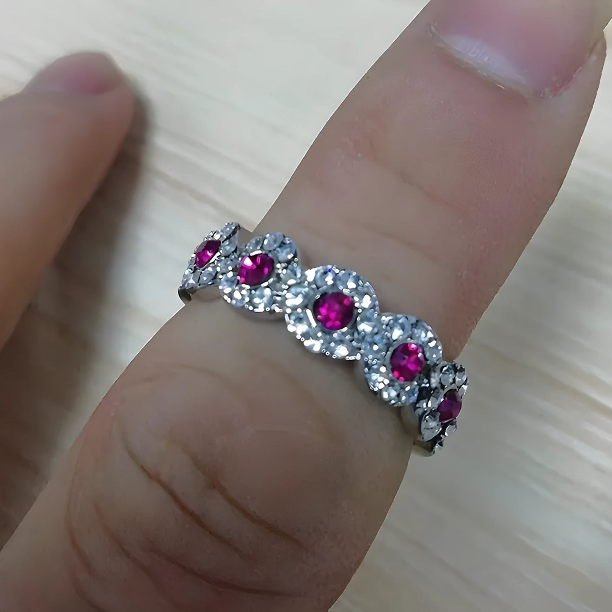 Micro-set ruby and green zircon ring in alloy, shown in green and gules with US size 5 to 12 chart